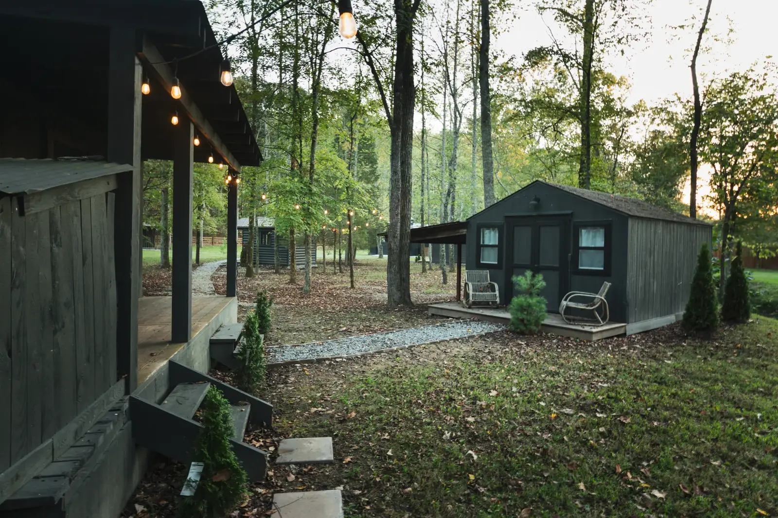 Cabins illuminated by string lights at dusk