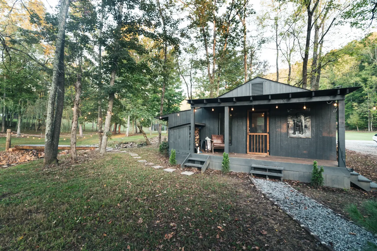 Dark cabin porch lit by warm string lights