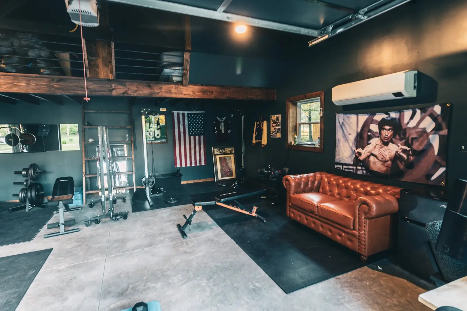 Gym lounge area with leather couch and projector