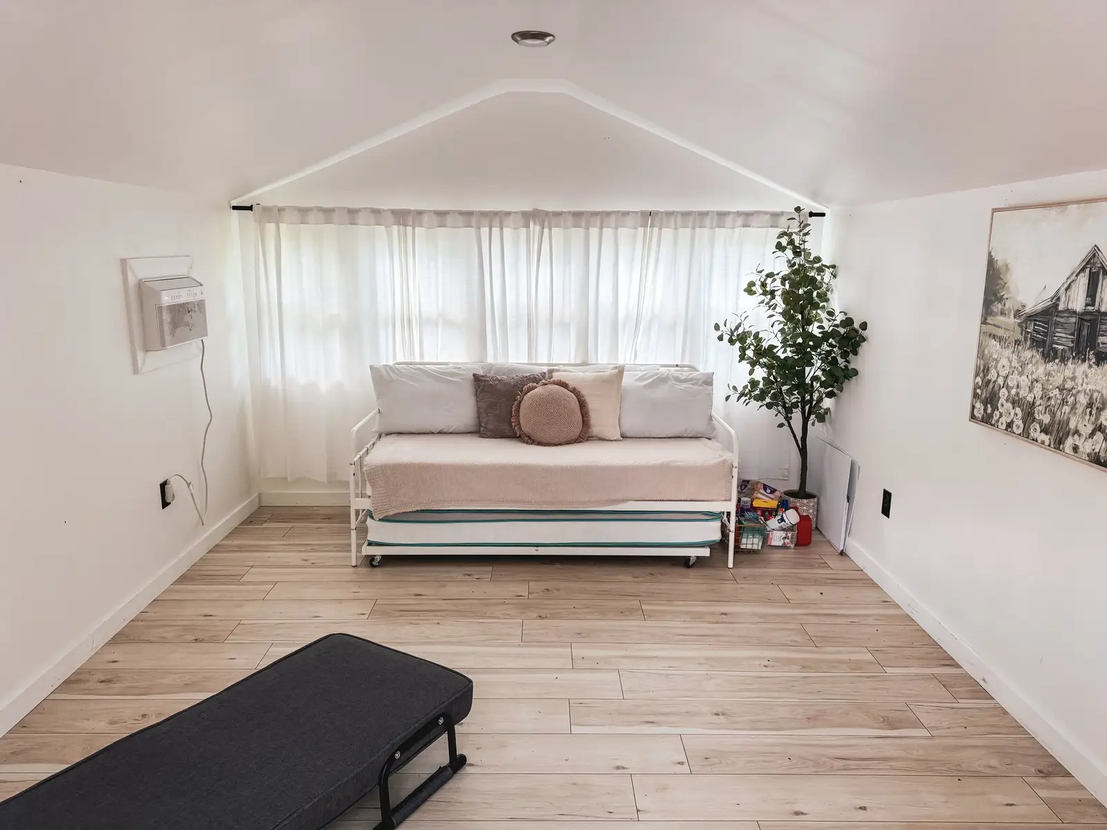 Cabin bedroom interior with daybed and natural light
