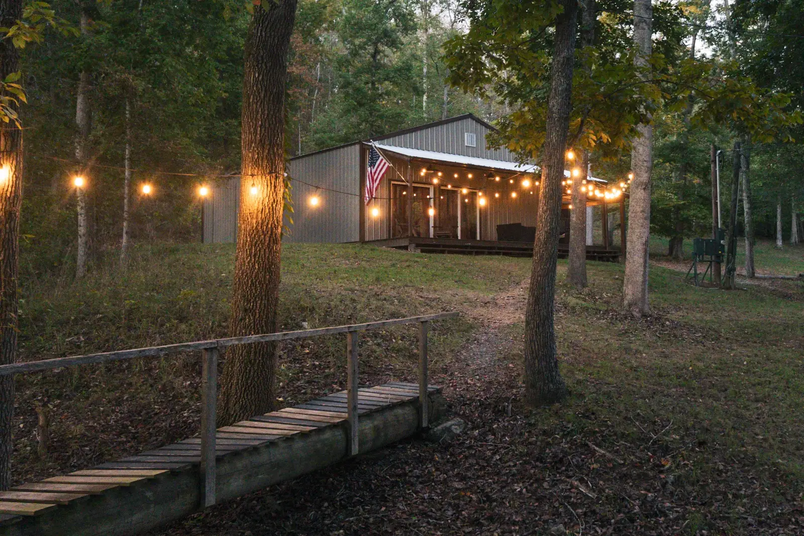 Main building glowing at dusk viewed from the bridge